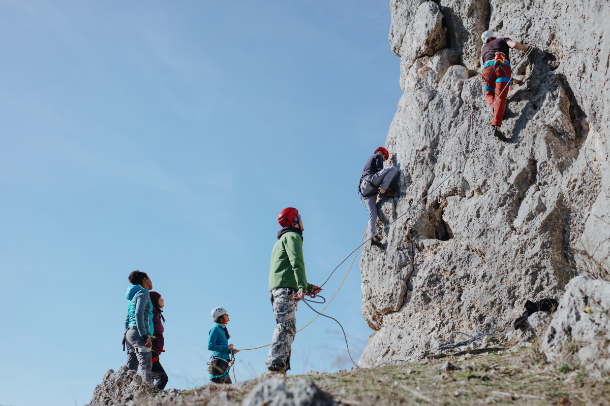 Two man climbs a rock with rope. Sport climbing, lead.